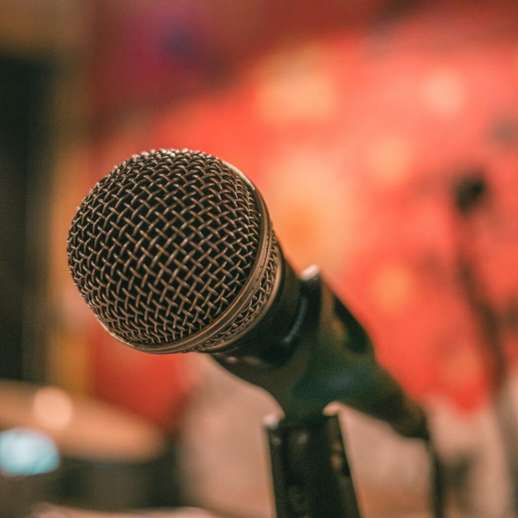 A microphone on a stand in a room.